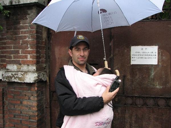2008年，一位父亲撑着伞，抱着女儿站在沙面大街68号门前